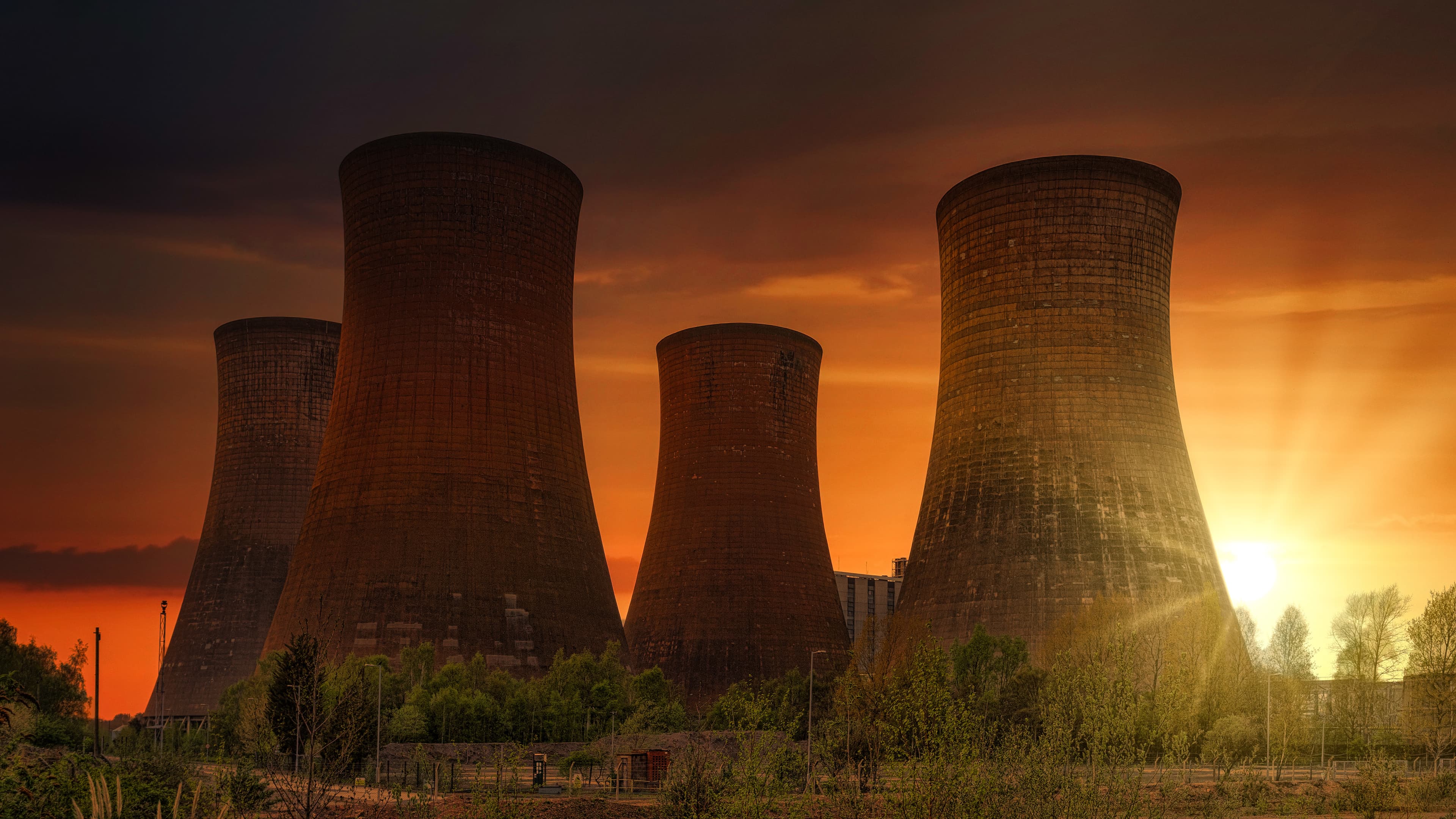 Industrial cooling towers at sunset